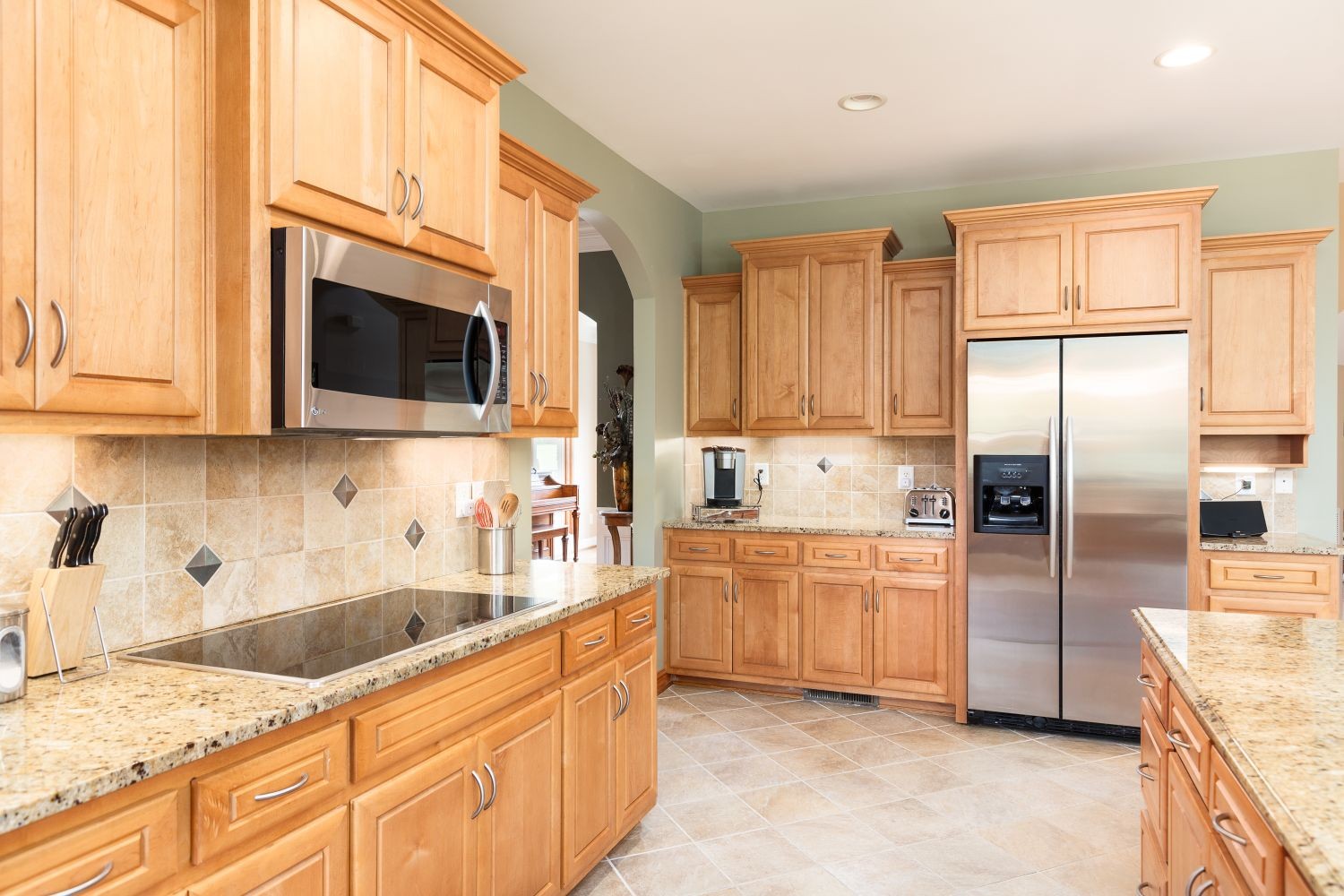 6326 Arno Road Franklin, TN 37064 - Photo 9 of 67 a kitchen with kitchen island granite countertop a sink stainless steel appliances and cabinets