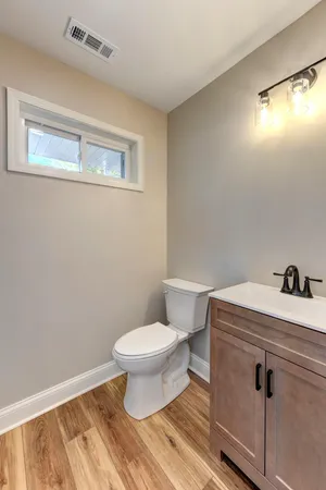 a bathroom with a toilet and a mirror
