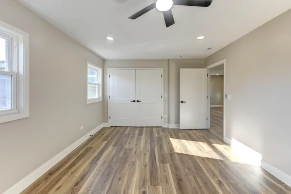 a view of empty room with wooden floor