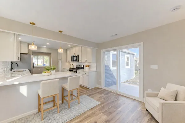 a large white kitchen with a large window