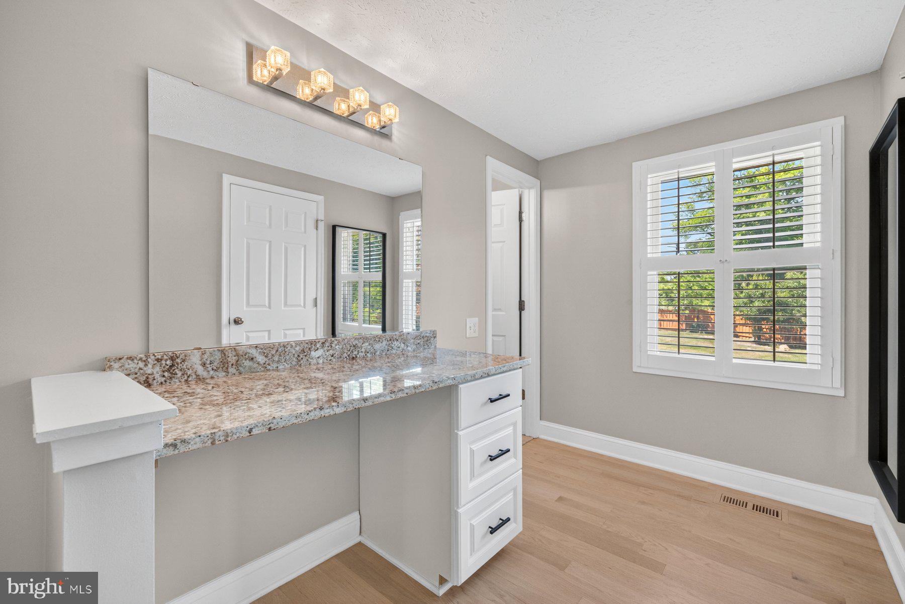7518 Candytuft Court Springfield, VA 22153 - Photo 18 of 47 a bathroom with a granite countertop sink and a mirror