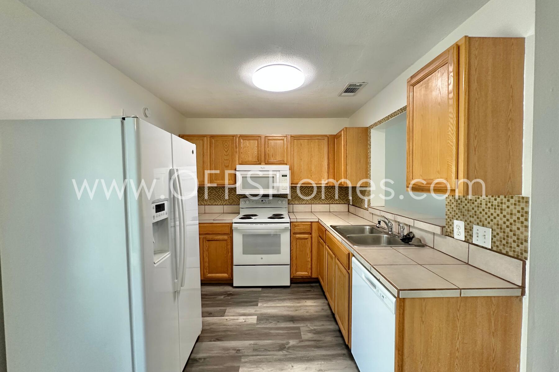 710 Legion Drive, Unit O2 Destin, FL 32541 - Photo 4 of 15 a kitchen with a refrigerator a sink dishwasher stove and oven