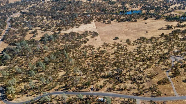 an aerial view of houses with a street