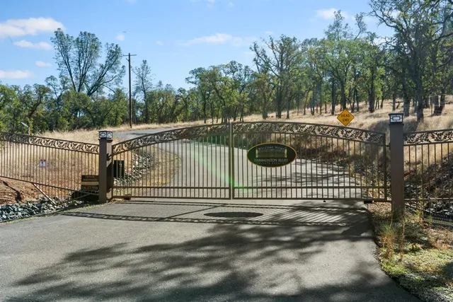 a view of a park with iron fence