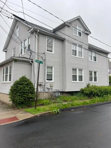 a front view of a house with a garden and yard