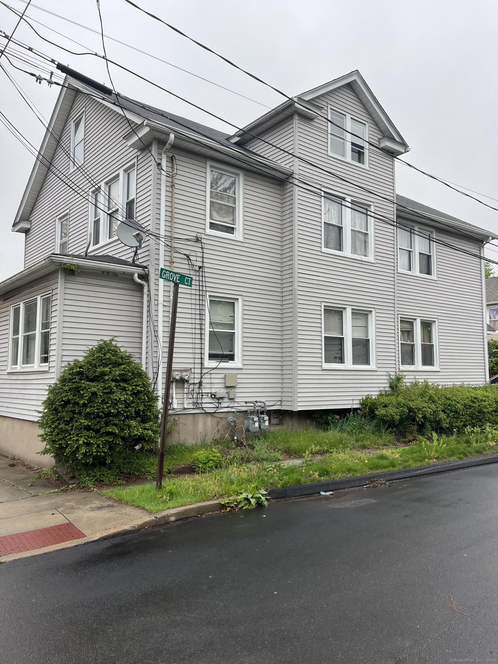 235 Grove Street Meriden, CT 06451 - Photo 1 of 3 a front view of a house with a garden and yard