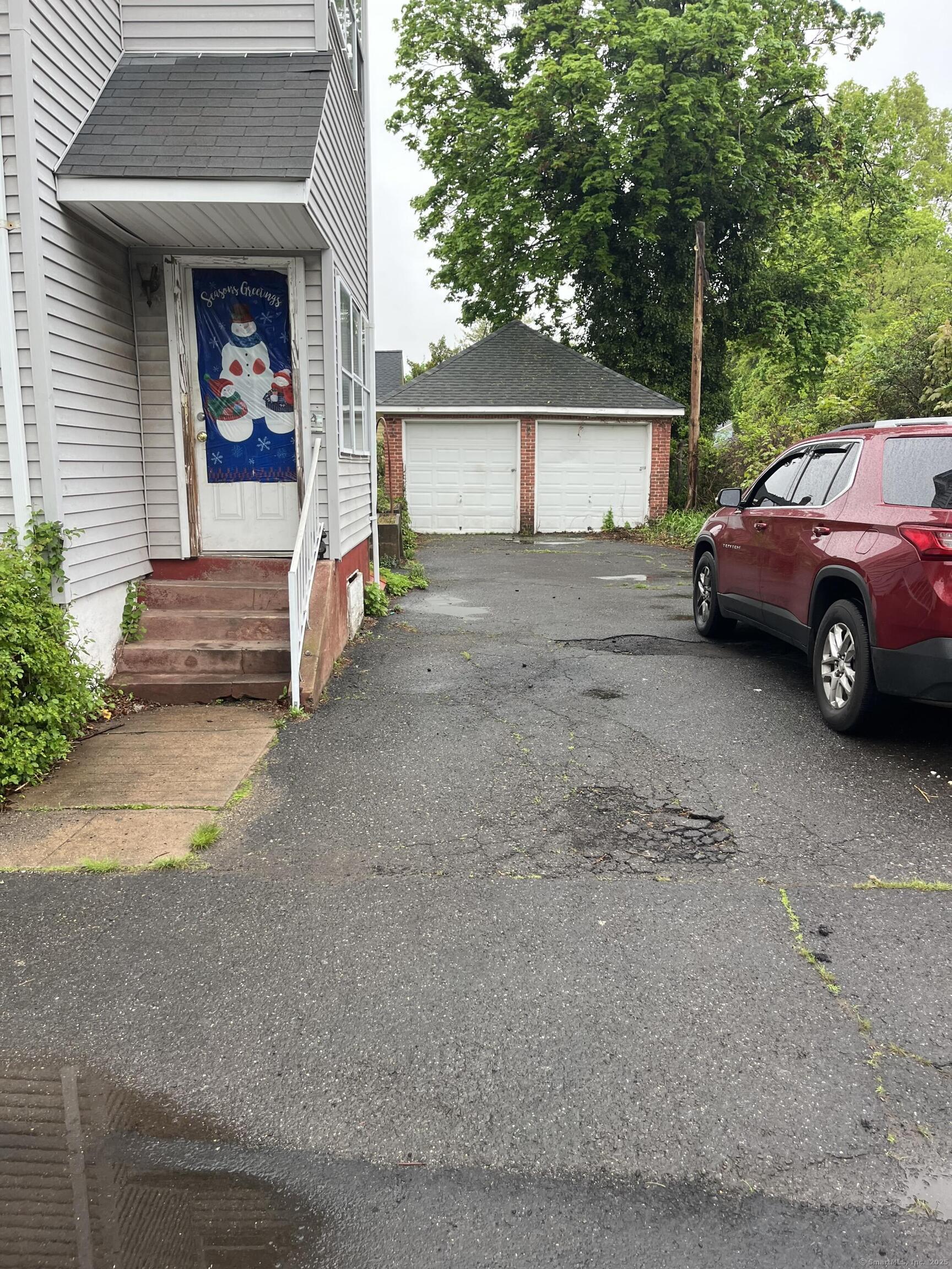 235 Grove Street Meriden, CT 06451 - Photo 3 of 3 a view of a car park in front of house