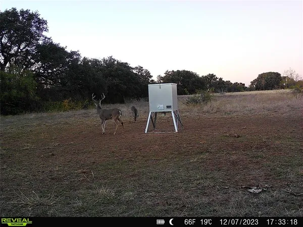 a view of a lake with a table and chairs in the patio