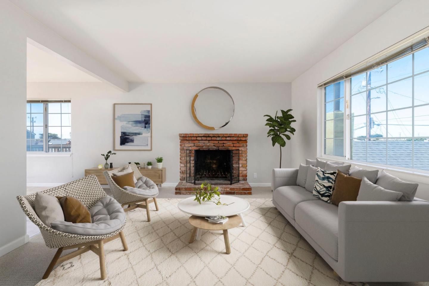 a living room with furniture a fireplace and a large window