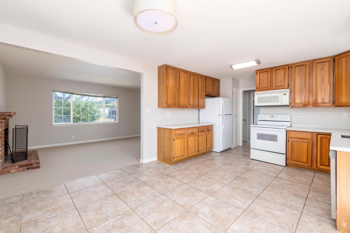 168 Salada Avenue Pacifica, CA 94044 - Photo 6 of 12 a kitchen with stainless steel appliances granite countertop a stove a sink and a refrigerator