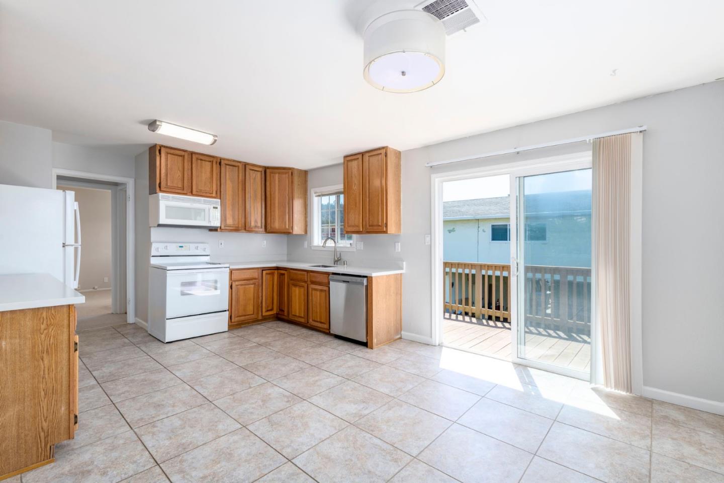 168 Salada Avenue Pacifica, CA 94044 - Photo 7 of 12 a large kitchen with cabinets and stainless steel appliances