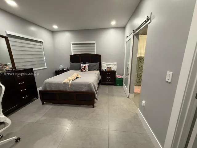 a bedroom with a bed and a mirror