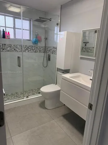 a view of a dining room with furniture and a chandelier
