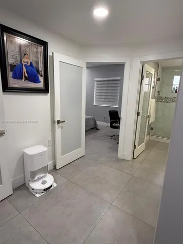 a view of a livingroom with wooden floor and a ceiling fan