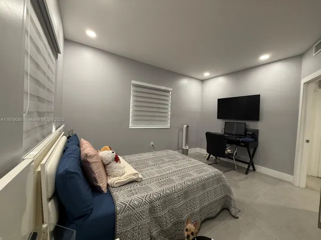 a bedroom with furniture and a window