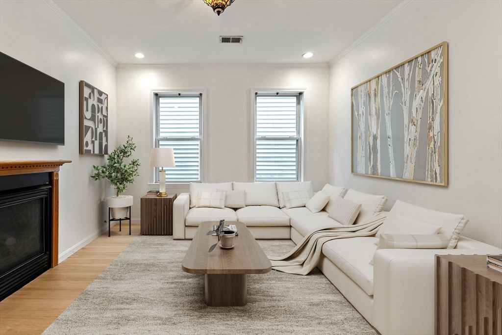 8 Peters Street, Unit B Boston, MA 02127 - Photo 4 of 14 a living room with furniture and a fireplace