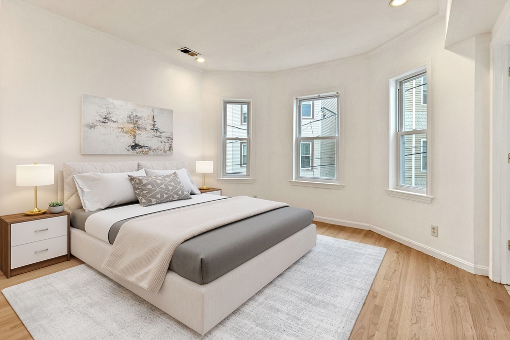 8 Peters Street, Unit B Boston, MA 02127 - Photo 5 of 14 a spacious bedroom with a large bed and a window