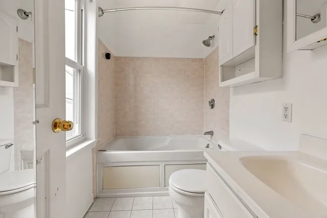 a bath room with a toilet and a bath tub