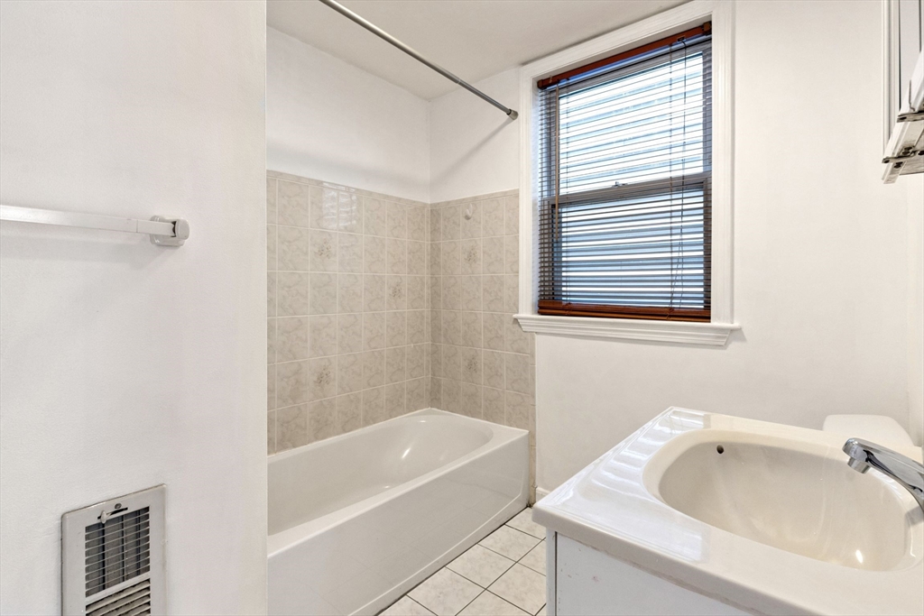 8 Peters Street, Unit B Boston, MA 02127 - Photo 10 of 14 a bathroom with a tub sink and shower