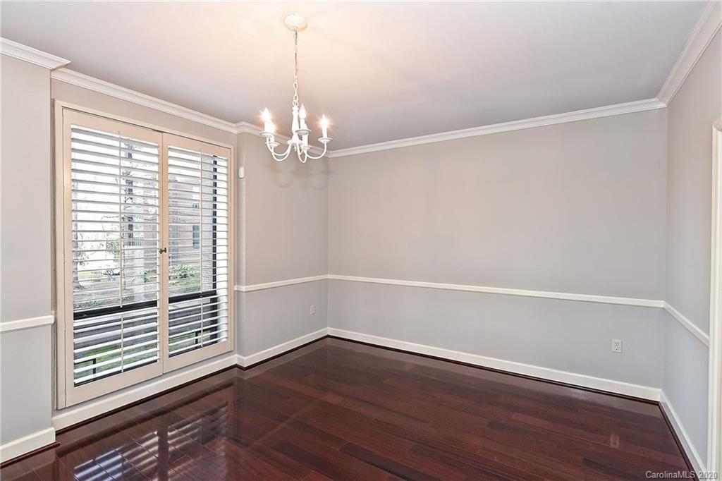 908 Cherokee Road, Unit 908 Charlotte, NC 28207 - Photo 12 of 35 a view of a livingroom with wooden floor and a large window
