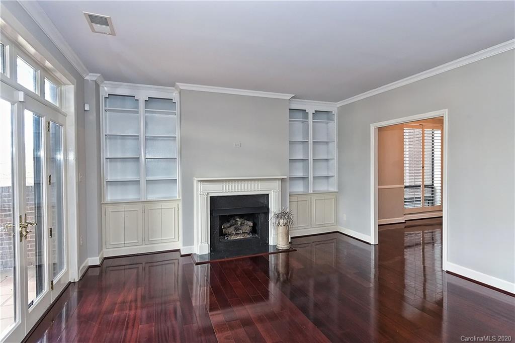 908 Cherokee Road, Unit 908 Charlotte, NC 28207 - Photo 15 of 35 an empty room with wooden floor fireplace and windows