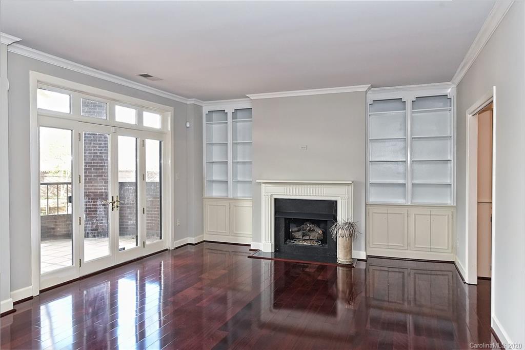 908 Cherokee Road, Unit 908 Charlotte, NC 28207 - Photo 16 of 35 a living room with wooden floor and a fireplace