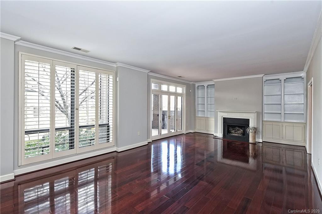 908 Cherokee Road, Unit 908 Charlotte, NC 28207 - Photo 18 of 35 a view of an empty room with wooden floor and a window