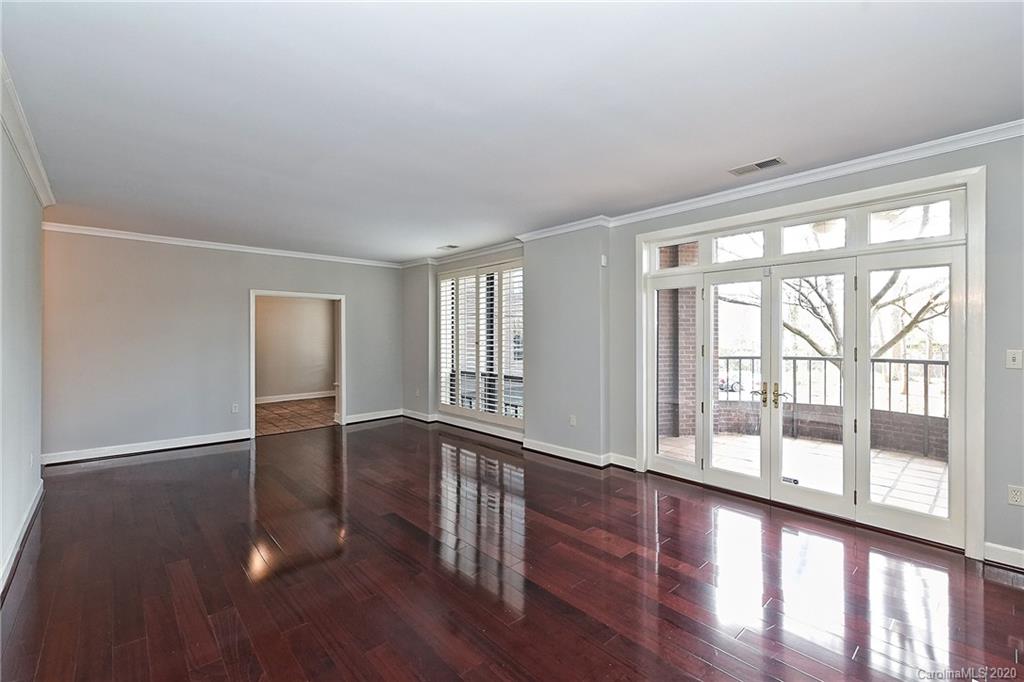 908 Cherokee Road, Unit 908 Charlotte, NC 28207 - Photo 19 of 35 wooden floor in an empty room with a window