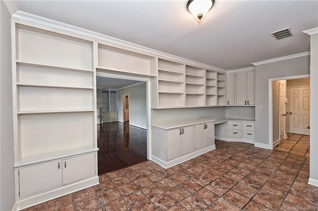 908 Cherokee Road, Unit 908 Charlotte, NC 28207 - Photo 20 of 35 a kitchen with white cabinets and window