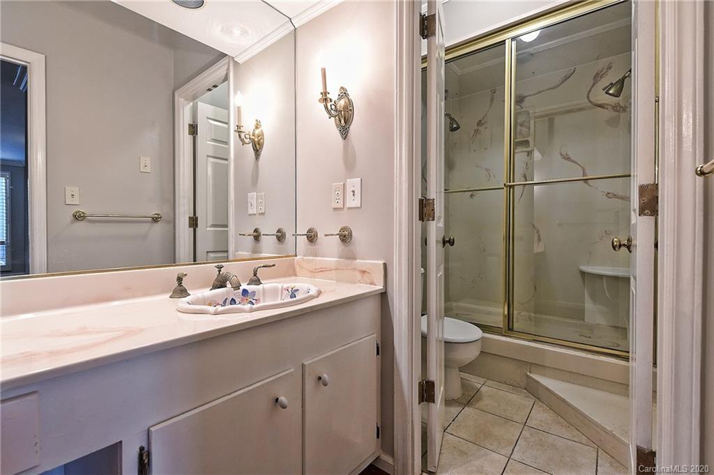 908 Cherokee Road, Unit 908 Charlotte, NC 28207 - Photo 26 of 35 a bathroom with a double vanity sink toilet and shower