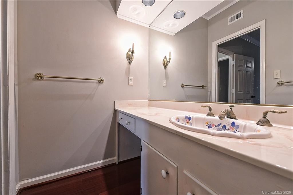 908 Cherokee Road, Unit 908 Charlotte, NC 28207 - Photo 27 of 35 a bathroom with a sink and a mirror