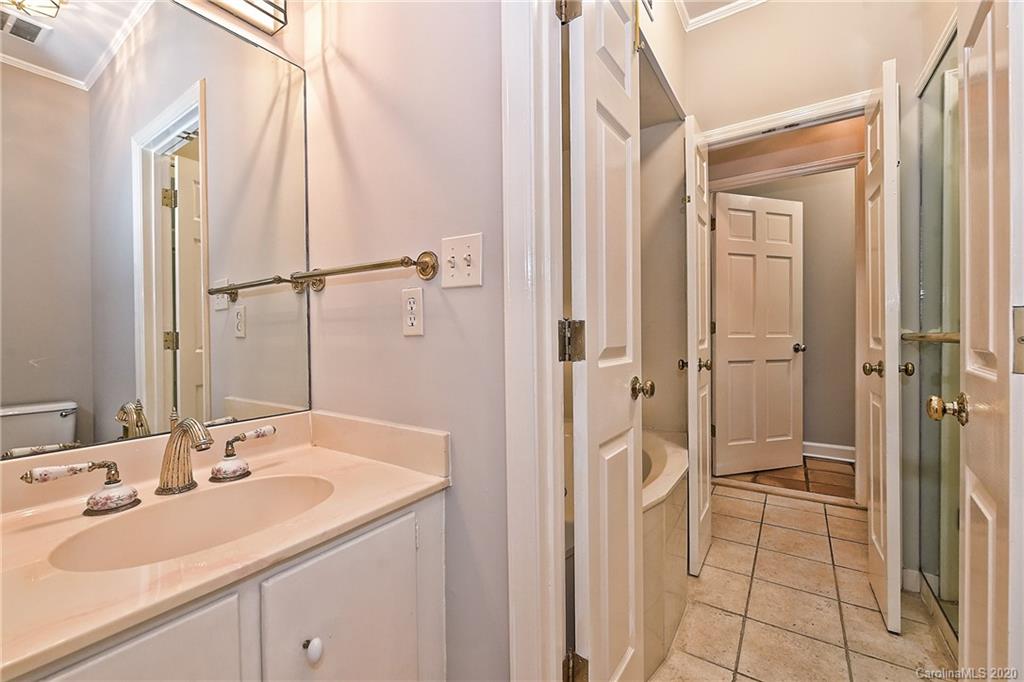 908 Cherokee Road, Unit 908 Charlotte, NC 28207 - Photo 30 of 35 a bathroom with a sink and a mirror