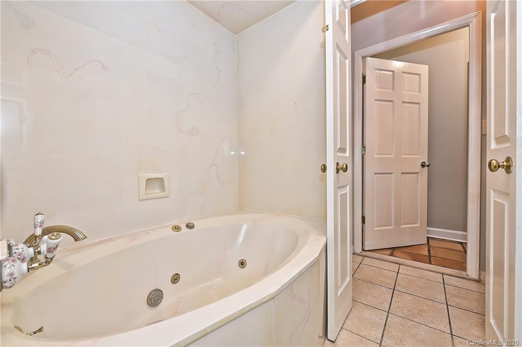 908 Cherokee Road, Unit 908 Charlotte, NC 28207 - Photo 31 of 35 a bathroom with a tub and a shower