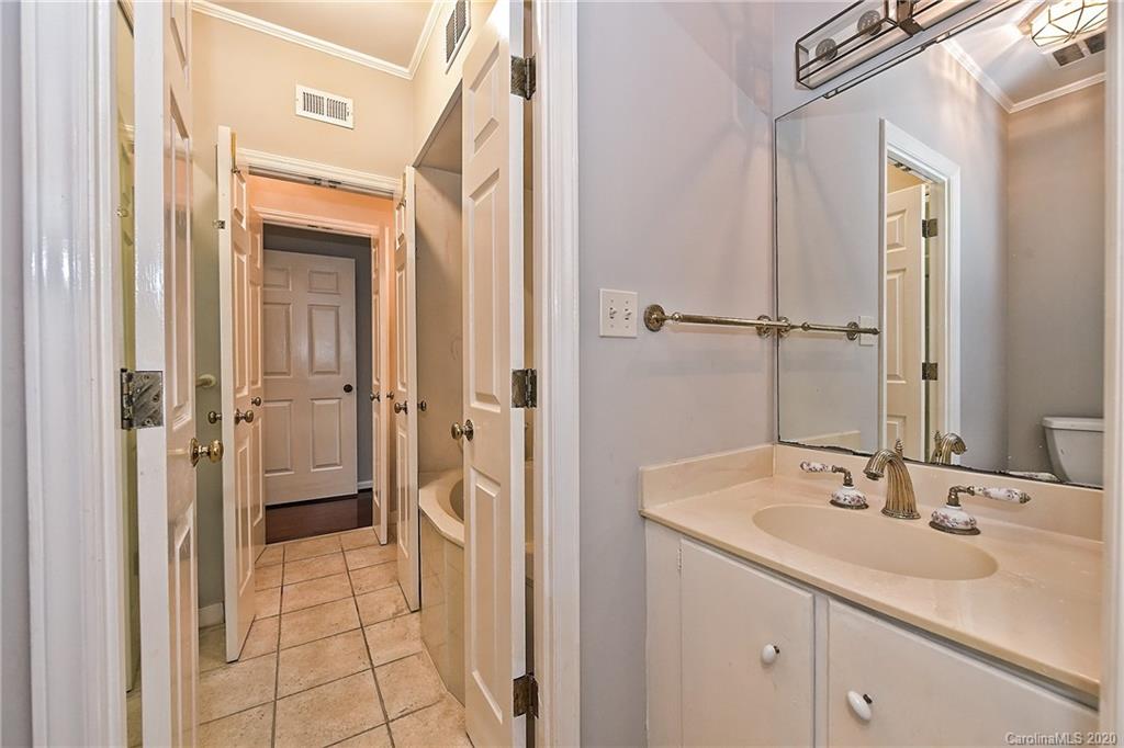 908 Cherokee Road, Unit 908 Charlotte, NC 28207 - Photo 32 of 35 a bathroom with a sink and a mirror