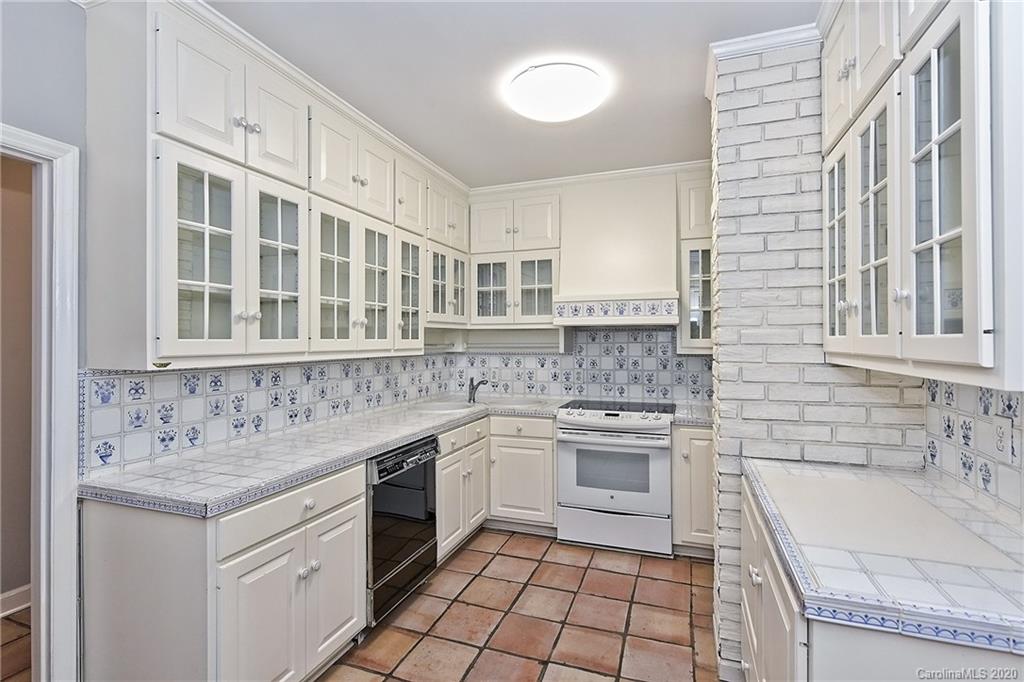 908 Cherokee Road, Unit 908 Charlotte, NC 28207 - Photo 5 of 35 a kitchen with a sink stove and cabinets