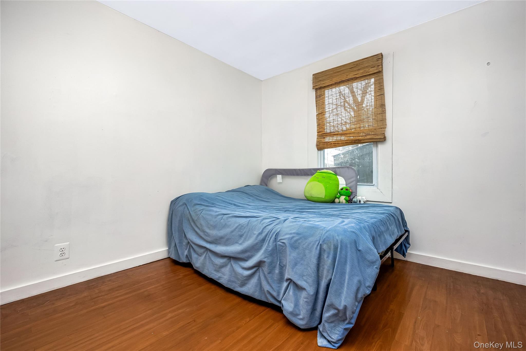 97 Berry Street Lindenhurst, NY 11757 - Photo 11 of 23 a bedroom with a bed and a window