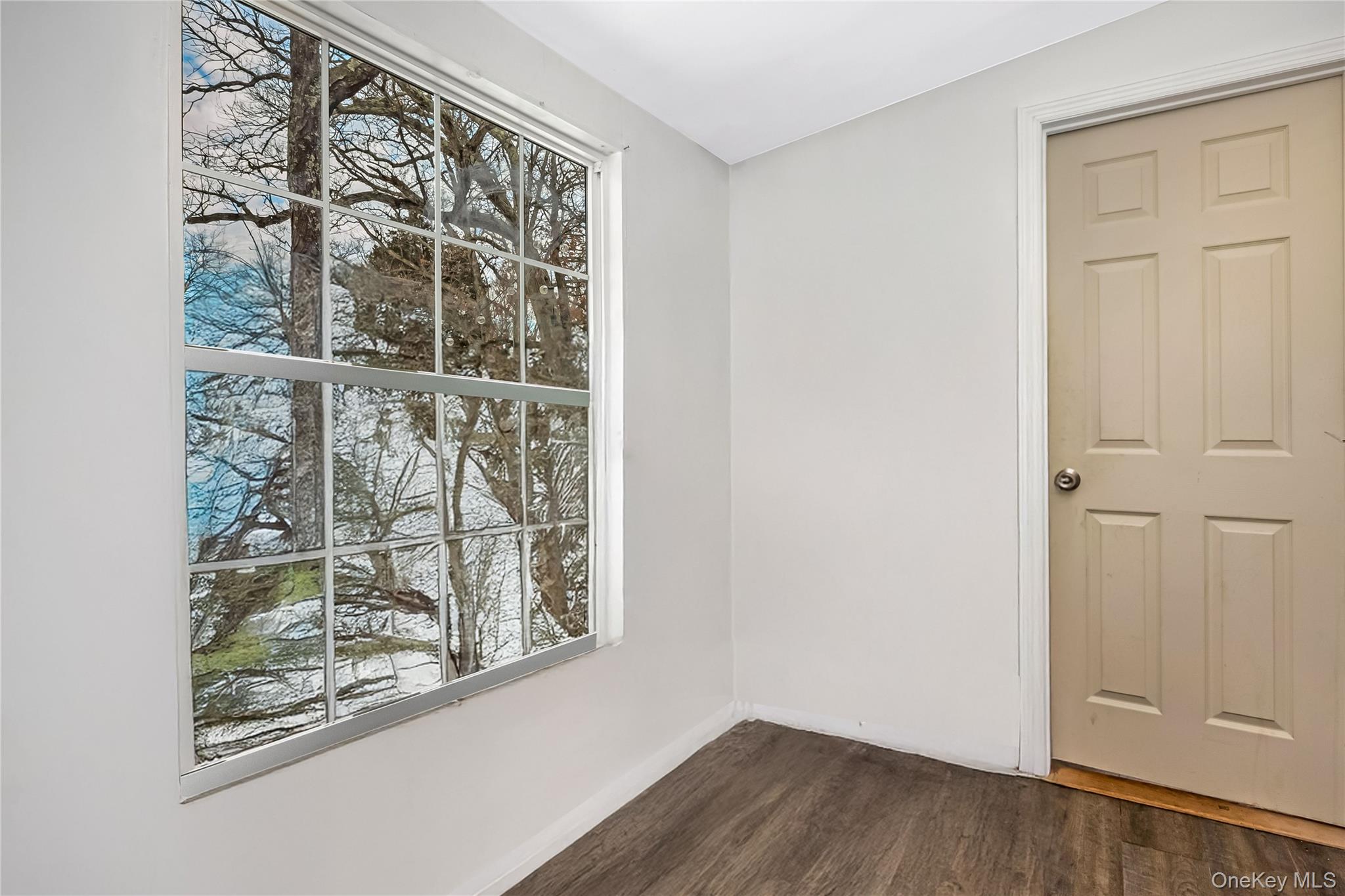 97 Berry Street Lindenhurst, NY 11757 - Photo 12 of 23 a view of a small space with wooden floor and a window