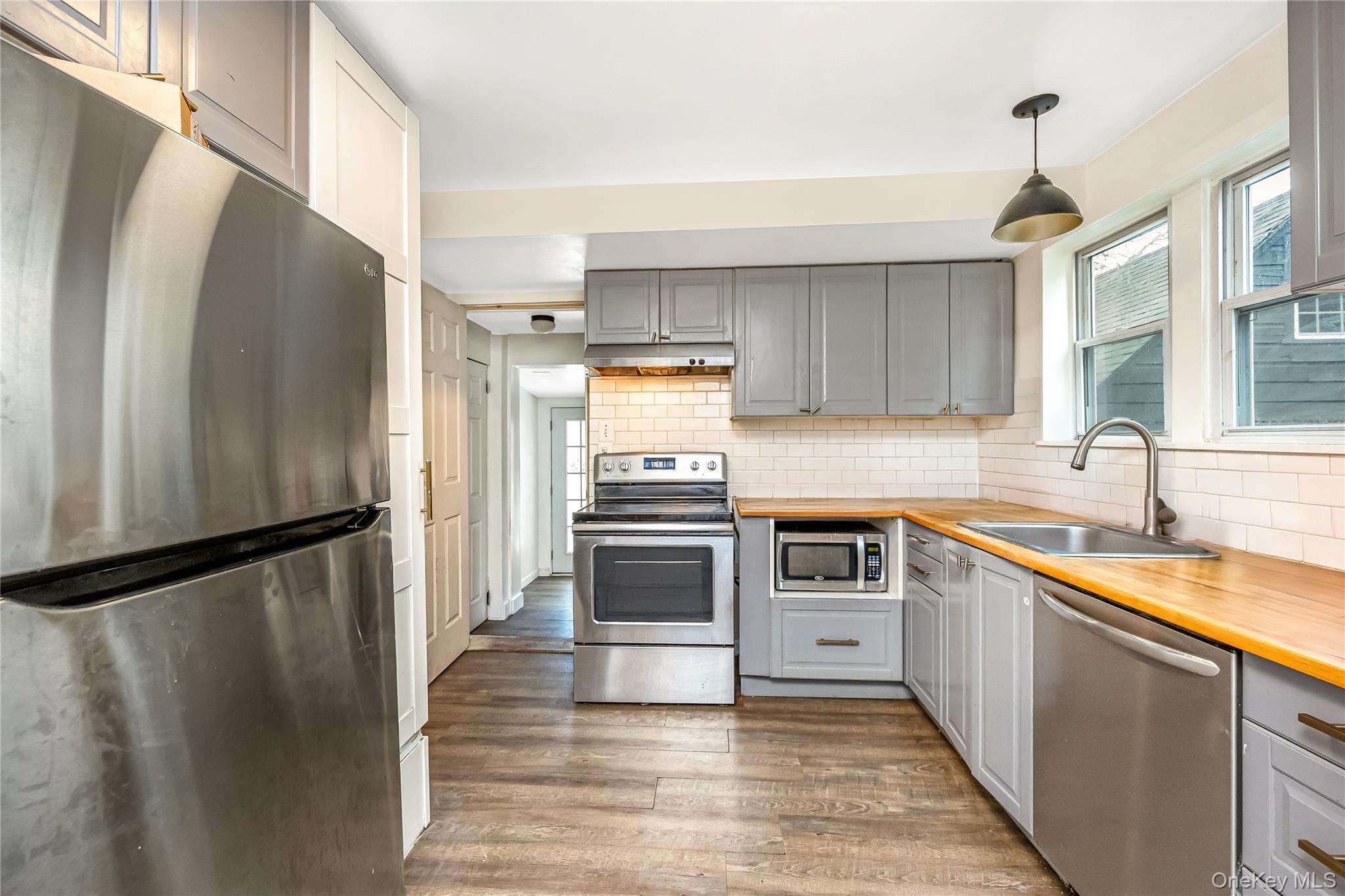 97 Berry Street Lindenhurst, NY 11757 - Photo 14 of 23 a kitchen with granite countertop a refrigerator and a sink