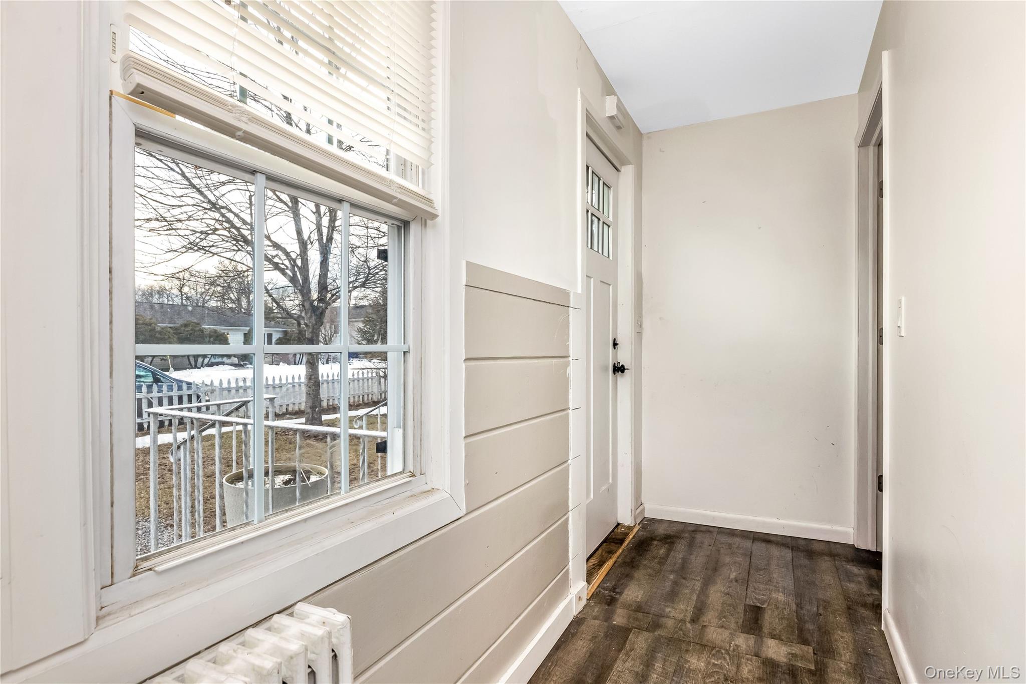 97 Berry Street Lindenhurst, NY 11757 - Photo 15 of 23 a view of empty room with wooden floor and fan
