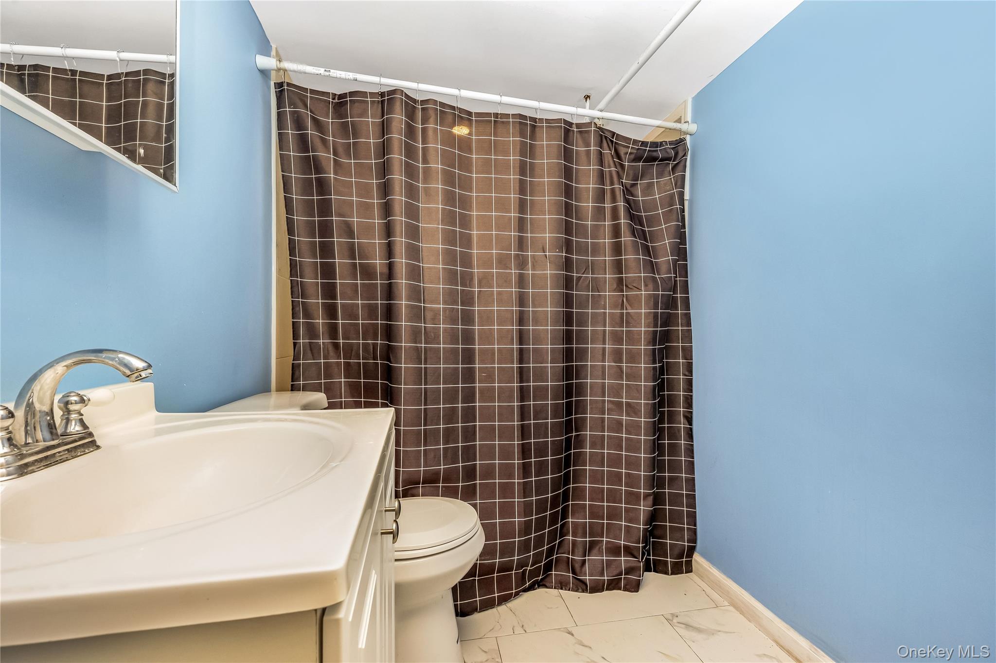 97 Berry Street Lindenhurst, NY 11757 - Photo 17 of 23 a bathroom with a sink toilet and shower