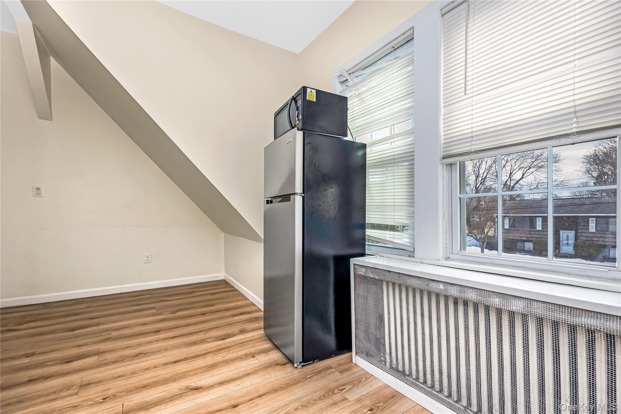 97 Berry Street Lindenhurst, NY 11757 - Photo 19 of 23 a view of a balcony with wooden floor and fence