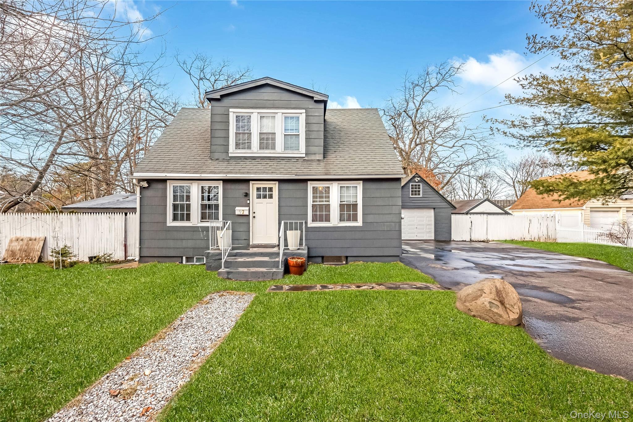 97 Berry Street Lindenhurst, NY 11757 - Photo 2 of 23 a front view of a house with a yard and trees