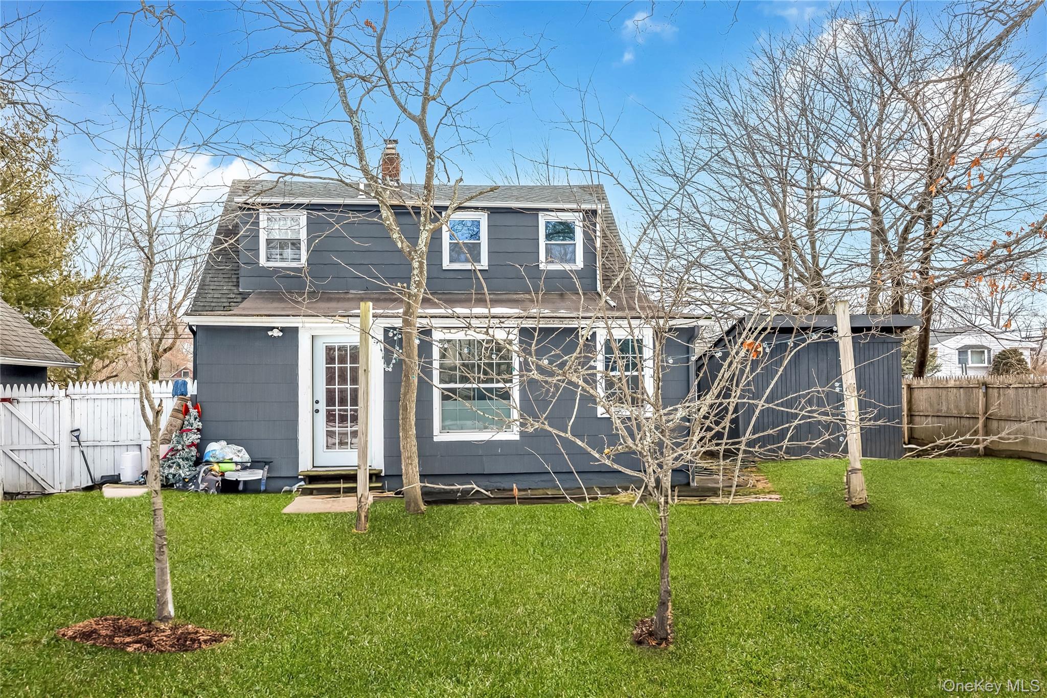 97 Berry Street Lindenhurst, NY 11757 - Photo 7 of 23 a view of a house with backyard and a tree
