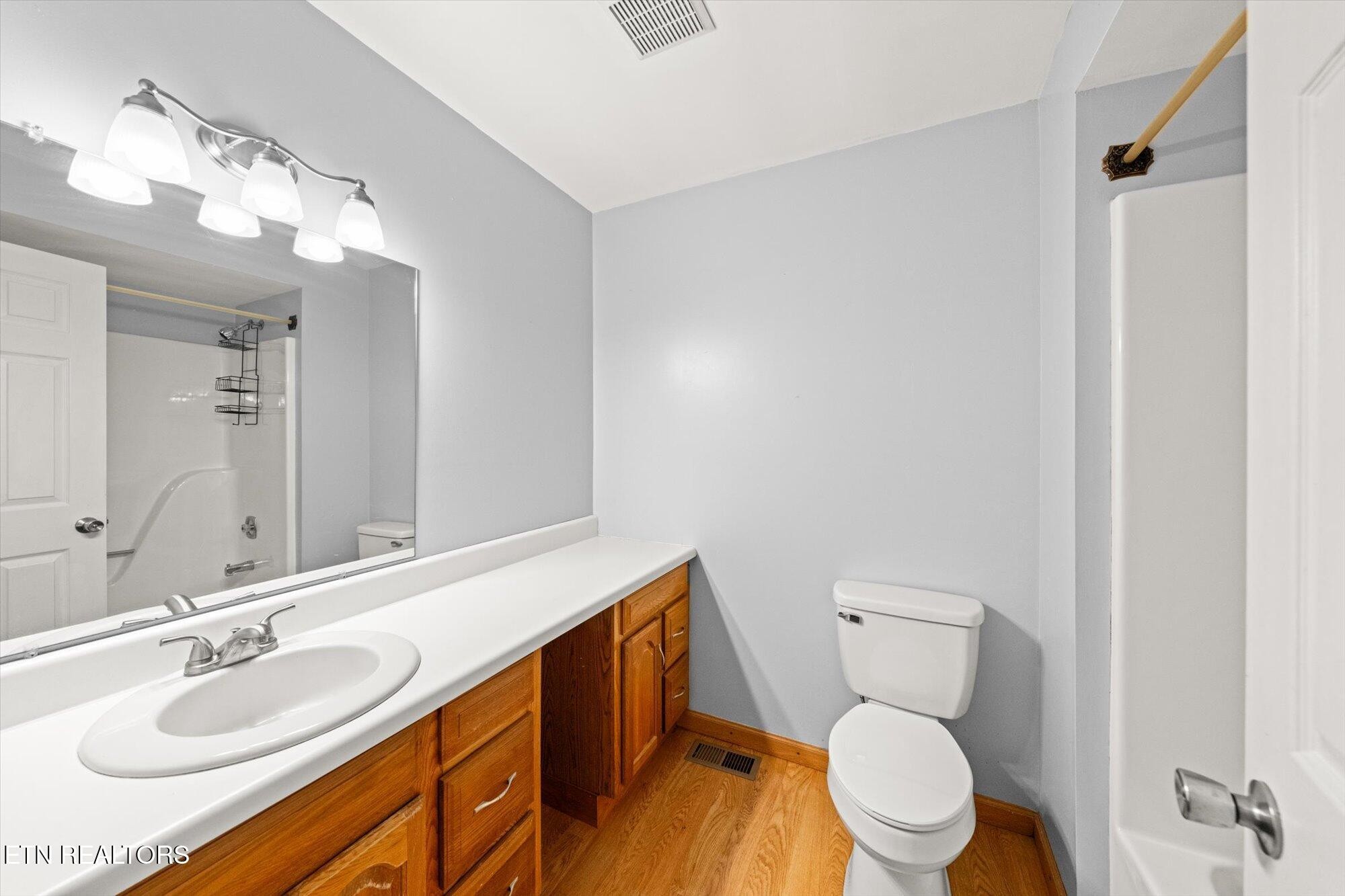 437 Oran Road Knoxville, TN 37934 - Photo 14 of 20 a bathroom with a granite countertop sink mirror vanity and toilet
