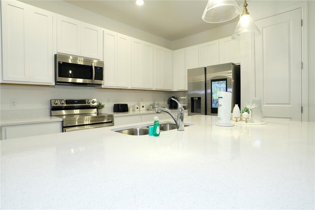 943 Conch Road Davenport, FL 33896 - Photo 13 of 43 a kitchen with a sink and a stove top oven