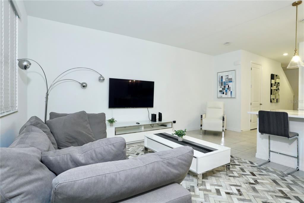 943 Conch Road Davenport, FL 33896 - Photo 15 of 43 a living room with furniture and a flat screen tv