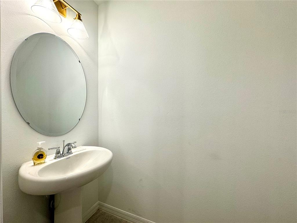 943 Conch Road Davenport, FL 33896 - Photo 19 of 43 a bathroom with a sink and a mirror