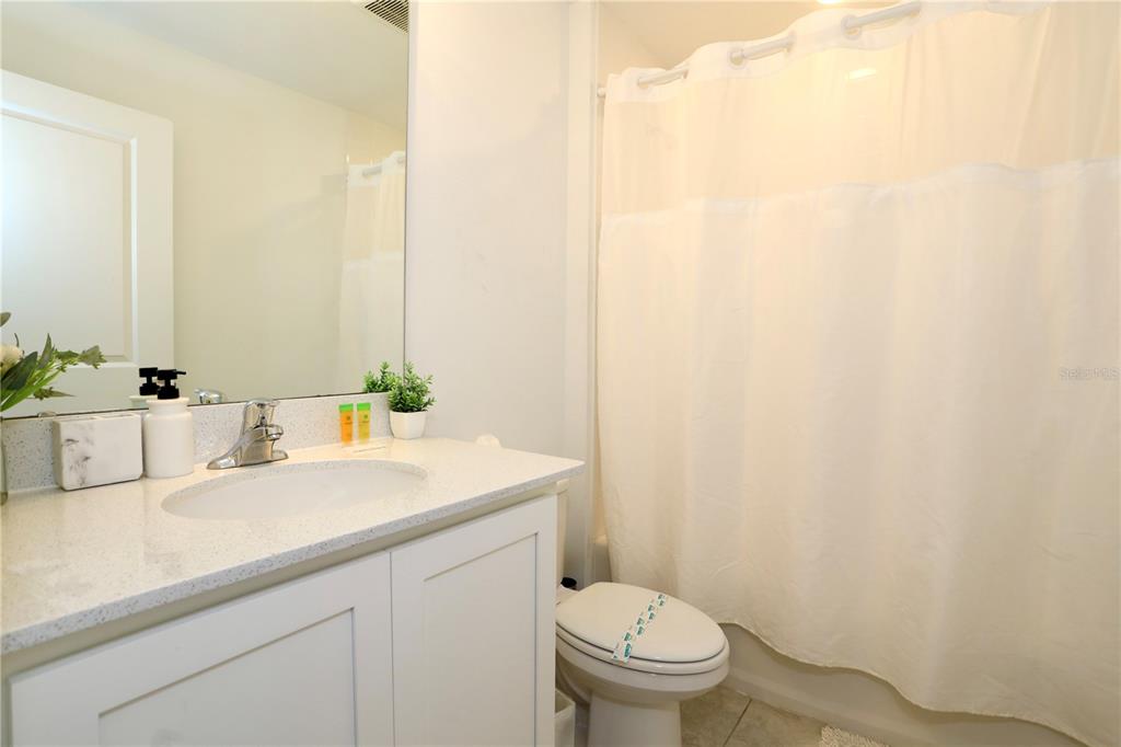 943 Conch Road Davenport, FL 33896 - Photo 25 of 43 a bathroom with a sink a toilet and mirror
