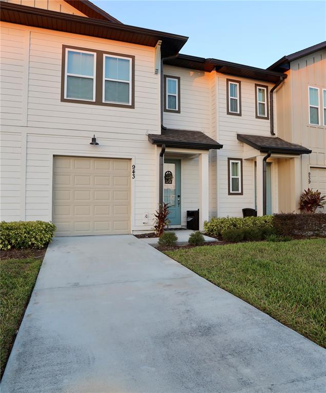 943 Conch Road Davenport, FL 33896 - Photo 34 of 43 a front view of a house with a yard and garage