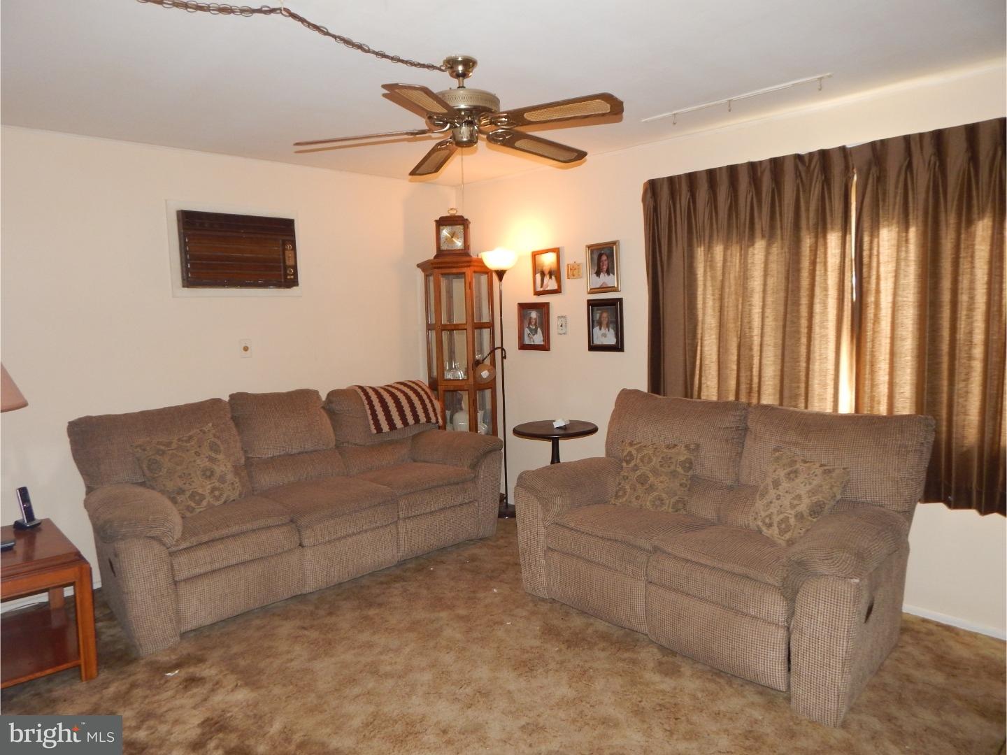 25 Downing Road Hamilton, NJ 08690 - Photo 6 of 14 a living room with furniture and a ceiling fan